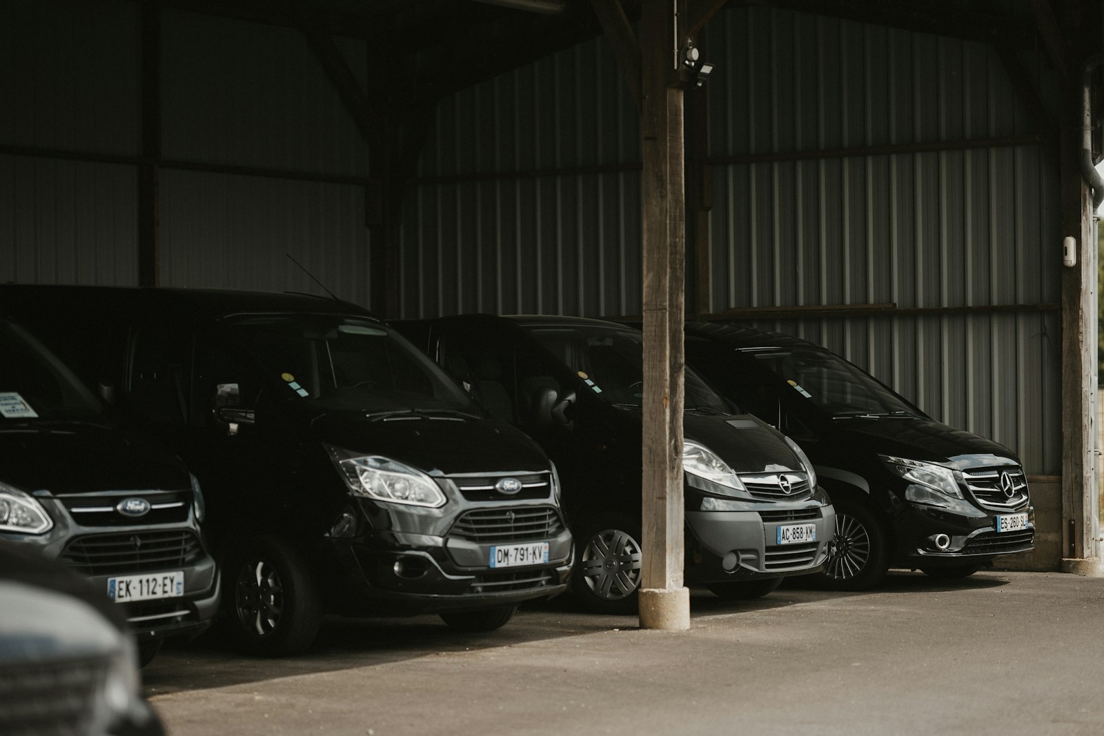 a row of parked cars in a garage, commercial auto